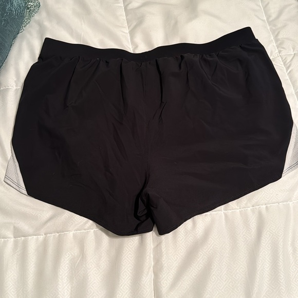 Under Armour black women's running shorts. White stripe on sides - Picture 2 of 3